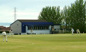 Ryan in action with new clubhouse in background...